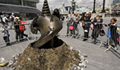 A large drill bit emerging from the ground on the south side of the river near to Tower Bridge.